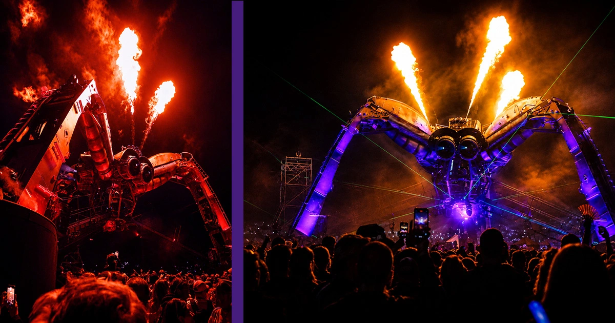 Arcadia's iconic mechanical spider stage illuminated with lasers, fire effects, projection mapping, and dynamic lighting during Glastonbury Festival at night. 